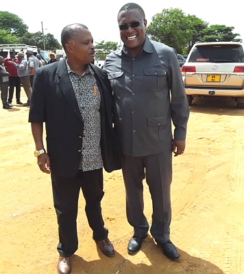 The-Chairman-of-MUET-and-Director-of-Tree-Planting-Mufindi-with-the-Minister-of-Information-Hon-Moses-Mnauye-enjoying-the-event-896x1008